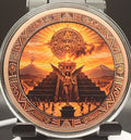 A round watch face featuring an intricate, detailed Mexican Aztec calendar and sun illustration in warm orange, brown, and gold tones, housed in a silver-toned metal case.