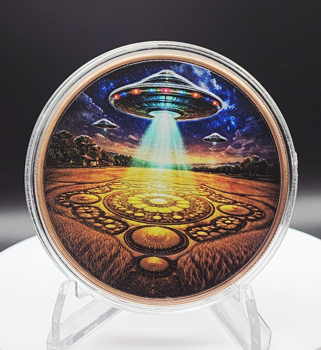 A circular acrylic display case containing a colorful sci-fi artwork of a UFO hovering over a glowing landscape, mounted on a clear stand against a dark studio background.