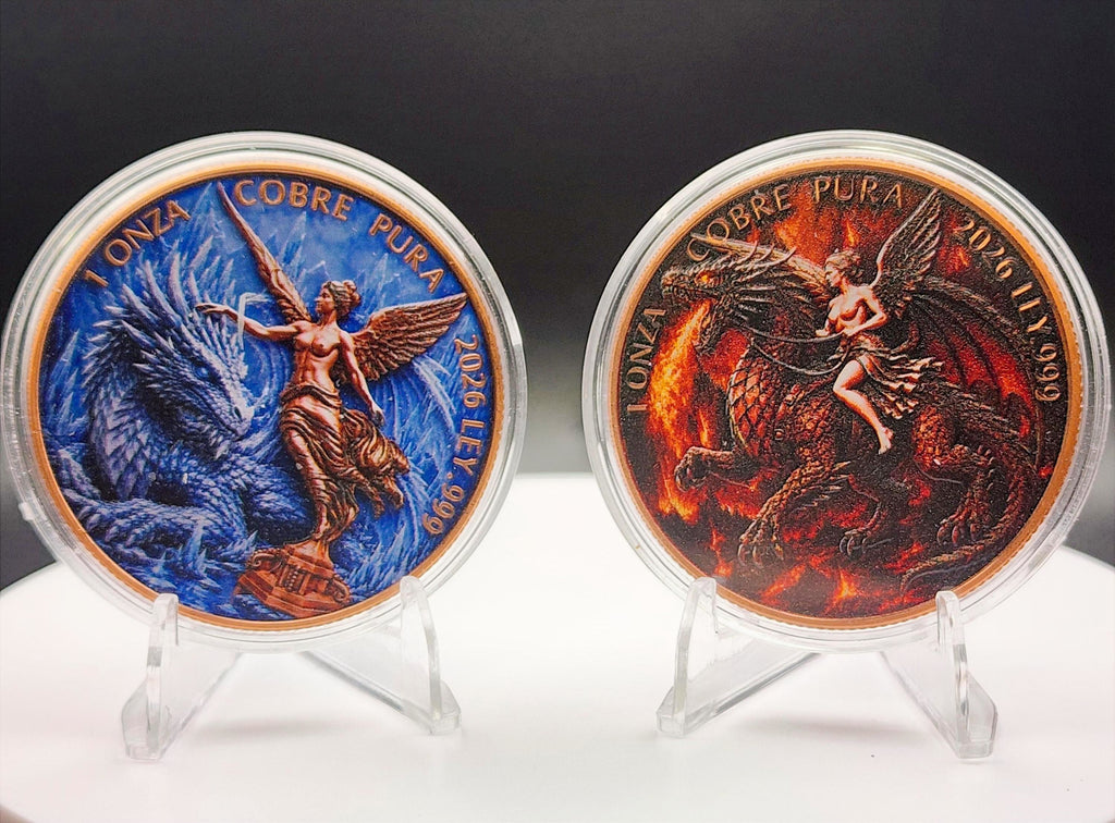 Two round collectible coins displayed side by side in clear plastic cases on small clear stands, set against a dark background with a white surface below. The left coin features a blue dragon and a bronze-toned winged figure with the text '1 ONZA COBRE PURA 2026 LII 979'.