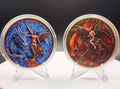 Two round collectible coins displayed side by side in clear plastic cases on small clear stands, set against a dark background with a white surface below. The left coin features a blue dragon and a bronze-toned winged figure with the text '1 ONZA COBRE PURA 2026 LII 979'.