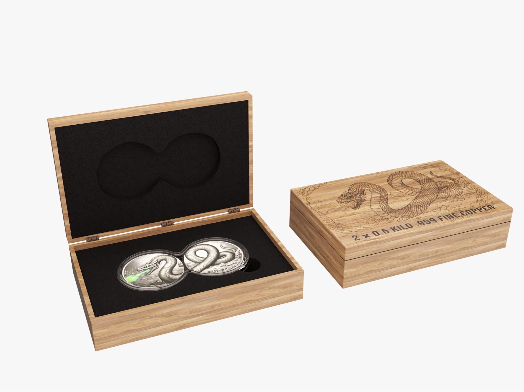 Two silver coins in a wooden box with a snake design on a white background